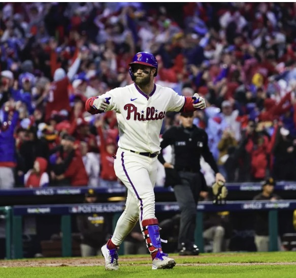 A Phillies hitter celebrates in front of a packed Citizens Bank Park crowd