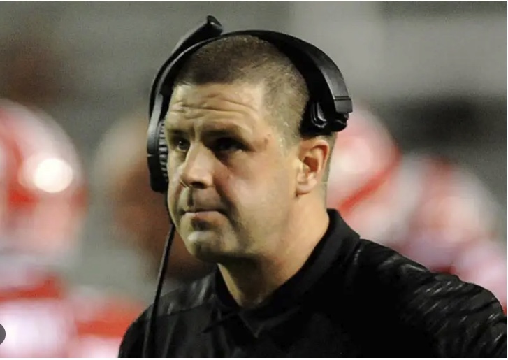 Billy Napier on the sideline in a headset